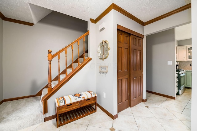 2862 Shady Ridge Dr, Columbus, OH 43231 - foyer entrance featuring ornamental molding, a textured ceiling, baseboards, and stairway
