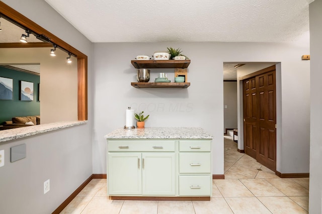 2862 Shady Ridge Dr, Columbus, OH 43231 - bar area with light tile patterned floors, a textured ceiling, and baseboards