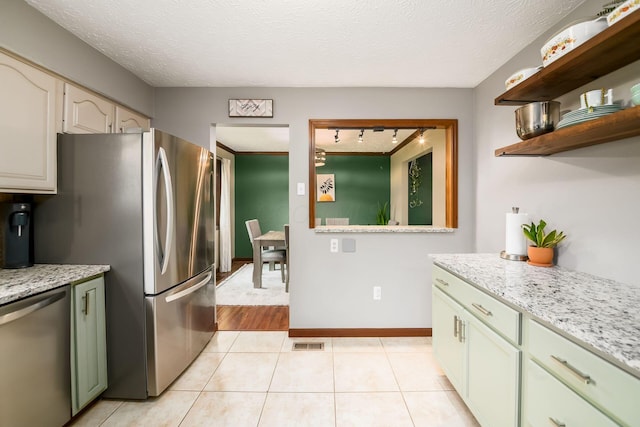 2862 Shady Ridge Dr, Columbus, OH 43231 - kitchen with stainless steel appliances, light tile patterned floors, light stone countertops, open shelves, and a textured ceiling
