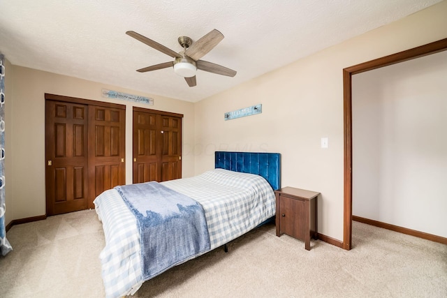 2862 Shady Ridge Dr, Columbus, OH 43231 - bedroom with light carpet, baseboards, a ceiling fan, and multiple closets