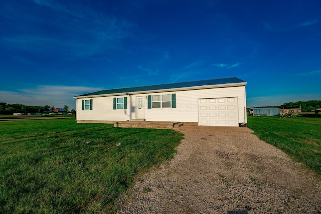 2025 Little Creek Rd, Frankfort, OH 45628 - view of front of home with an attached garage, driveway, a front lawn, and metal roof