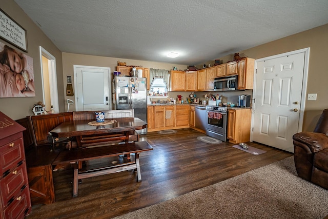 2025 Little Creek Rd, Frankfort, OH 45628 - kitchen with appliances with stainless steel finishes, dark wood-type flooring, a textured ceiling, and light countertops