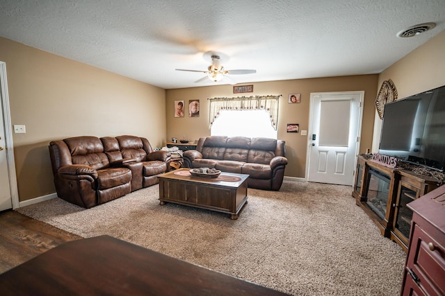 2025 Little Creek Rd, Frankfort, OH 45628 - living room with ceiling fan, baseboards, a textured ceiling, and wood finished floors
