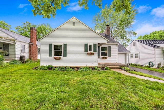 157 E Dominion Blvd, Columbus, OH 43214 - rear view of property featuring a lawn and a chimney