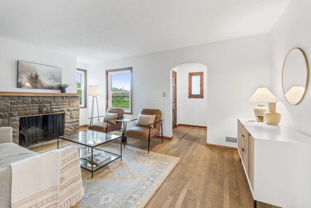 157 E Dominion Blvd, Columbus, OH 43214 - living room with arched walkways, light wood-type flooring, baseboards, and a fireplace