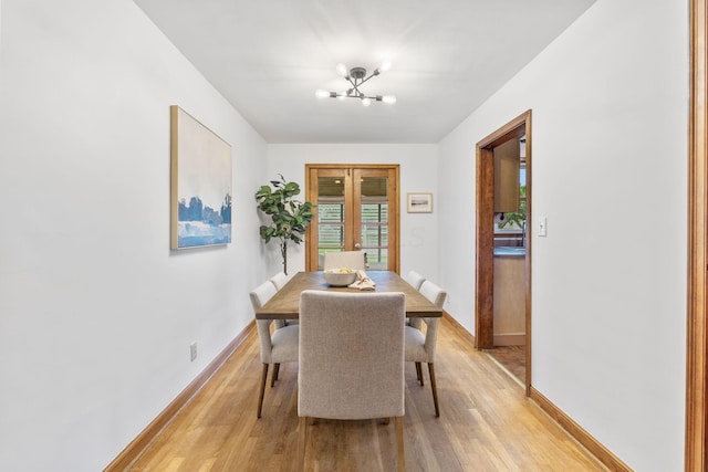 157 E Dominion Blvd, Columbus, OH 43214 - dining space featuring light wood-type flooring, a chandelier, french doors, and baseboards
