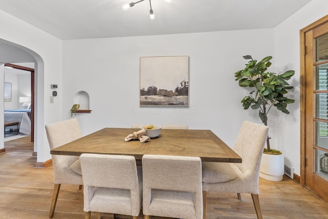 157 E Dominion Blvd, Columbus, OH 43214 - dining room featuring light wood-style flooring, arched walkways, and baseboards