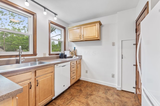157 E Dominion Blvd, Columbus, OH 43214 - kitchen featuring white appliances, a sink, light brown cabinetry, rail lighting, and baseboards