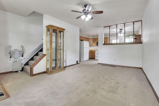 2294 Perkins Ct, Columbus, OH 43229 - unfurnished living room with a ceiling fan, light carpet, and baseboards