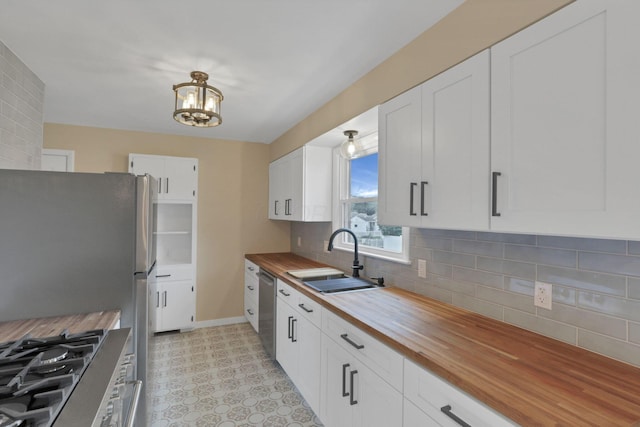 1783 Glenmar Dr, Lancaster, OH 43130 - kitchen featuring butcher block countertops, a sink, appliances with stainless steel finishes, a chandelier, and white cabinetry
