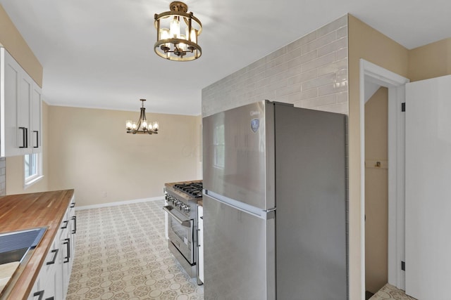 1783 Glenmar Dr, Lancaster, OH 43130 - kitchen featuring stainless steel appliances, wooden counters, a chandelier, white cabinetry, and light colored carpet