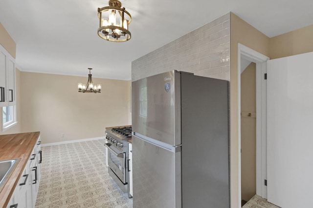 1783 Glenmar Dr, Lancaster, OH 43130 - kitchen with stainless steel appliances, a chandelier, butcher block counters, and white cabinetry