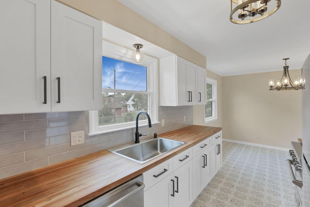 1783 Glenmar Dr, Lancaster, OH 43130 - kitchen featuring a chandelier, butcher block countertops, a sink, baseboards, and white cabinetry