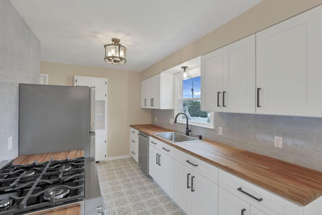 1783 Glenmar Dr, Lancaster, OH 43130 - kitchen featuring butcher block counters, a sink, appliances with stainless steel finishes, and a chandelier