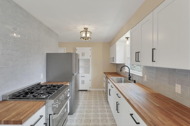 1783 Glenmar Dr, Lancaster, OH 43130 - kitchen featuring butcher block counters, stainless steel appliances, a sink, and decorative backsplash