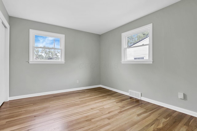 1783 Glenmar Dr, Lancaster, OH 43130 - unfurnished bedroom with multiple windows, a closet, and light wood-type flooring
