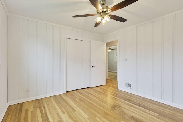 1783 Glenmar Dr, Lancaster, OH 43130 - unfurnished bedroom with light wood-type flooring, a decorative wall, baseboards, ornamental molding, and a ceiling fan
