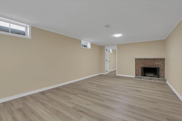 1783 Glenmar Dr, Lancaster, OH 43130 - unfurnished living room featuring light wood-style floors, baseboards, a brick fireplace, healthy amount of natural light, and ornamental molding