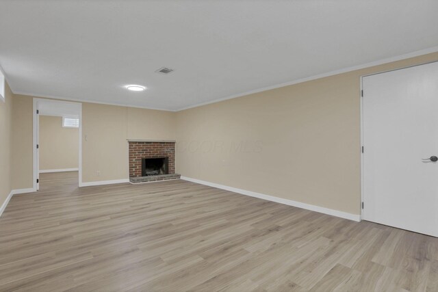 1783 Glenmar Dr, Lancaster, OH 43130 - unfurnished living room featuring light wood-type flooring, ornamental molding, baseboards, and a brick fireplace