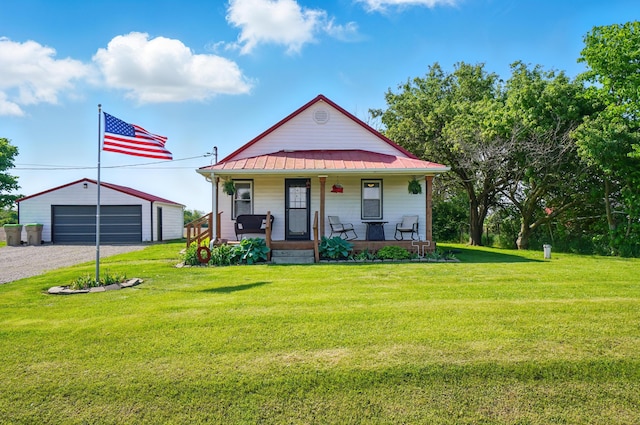 11725 Old Columbus Rd, South Vienna, OH 45369 - view of front of home with a porch, an outbuilding, a front lawn, metal roof, and a garage