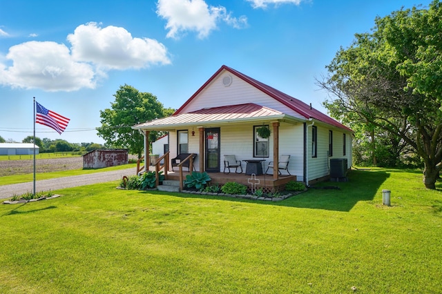 11725 Old Columbus Rd, South Vienna, OH 45369 - view of front of home featuring covered porch, central air condition unit, a front yard, metal roof, and a standing seam roof