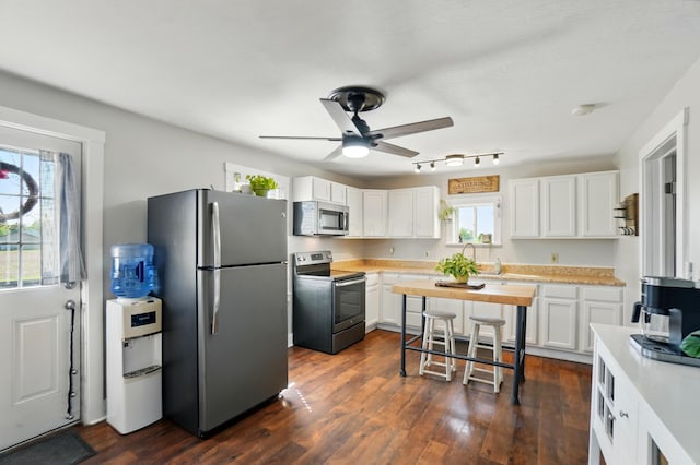11725 Old Columbus Rd, South Vienna, OH 45369 - kitchen featuring stainless steel appliances, light countertops, white cabinetry, and ceiling fan
