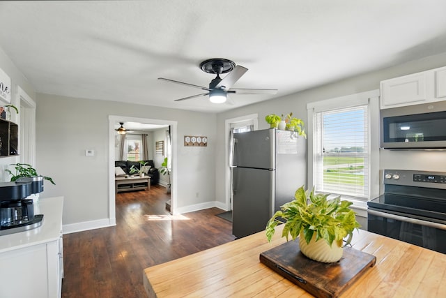 11725 Old Columbus Rd, South Vienna, OH 45369 - dining space featuring ceiling fan, dark wood-style floors, and baseboards