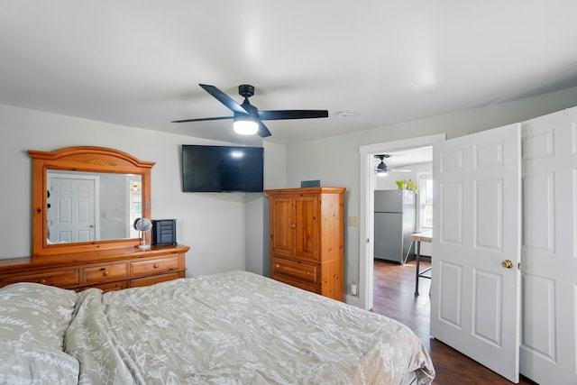 11725 Old Columbus Rd, South Vienna, OH 45369 - bedroom featuring freestanding refrigerator, dark wood finished floors, and a ceiling fan