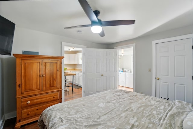 11725 Old Columbus Rd, South Vienna, OH 45369 - bedroom featuring washer and dryer, dark wood-style flooring, connected bathroom, and a ceiling fan
