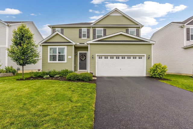 324 Raccoon Ave, Johnstown, OH 43031 - traditional-style house with asphalt driveway, a front lawn, and a garage