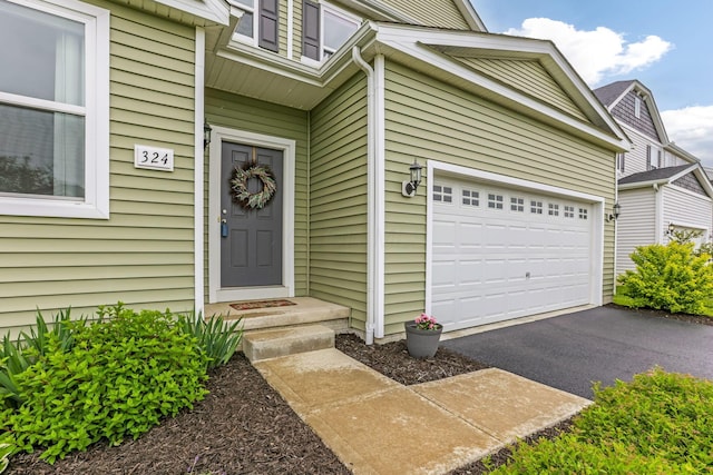 324 Raccoon Ave, Johnstown, OH 43031 - property entrance featuring asphalt driveway and a garage