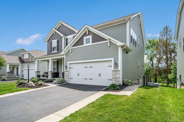 2991 Green Line Way, Columbus, OH 43231 - craftsman inspired home featuring asphalt driveway, a front yard, an attached garage, stone siding, and covered porch