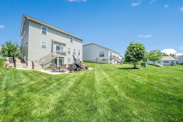 2991 Green Line Way, Columbus, OH 43231 - rear view of house with stairway, a patio, and a yard