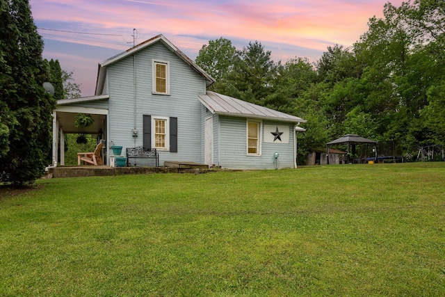 3470 State Route 314, Fredericktown, OH 43019 - back of house at dusk featuring a gazebo, a lawn, metal roof, and a standing seam roof