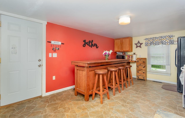 3470 State Route 314, Fredericktown, OH 43019 - indoor dry bar with stone floors, stainless steel microwave, and baseboards