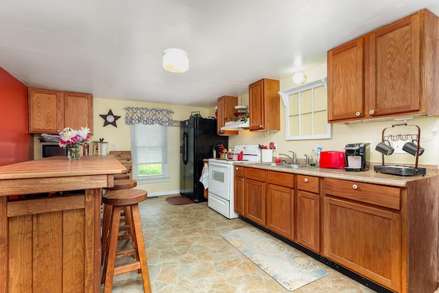 3470 State Route 314, Fredericktown, OH 43019 - kitchen featuring white range with electric cooktop, a sink, black fridge with ice dispenser, under cabinet range hood, and light countertops