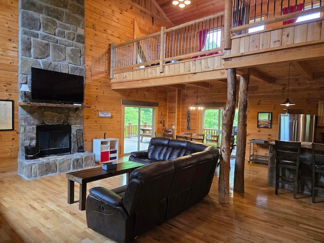 21760 State Route 93, Logan, OH 43138 - living area with high vaulted ceiling, wood walls, a fireplace, hardwood / wood-style floors, and wood ceiling with exposed beams