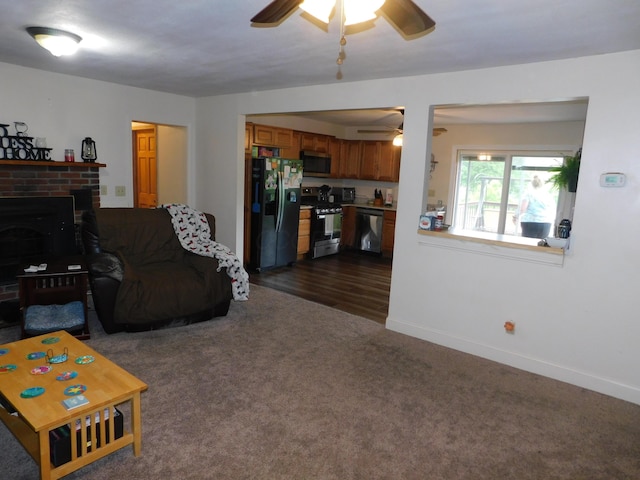 21800 State Route 47, West Mansfield, OH 43358 - living area with ceiling fan, dark colored carpet, baseboards, and a fireplace
