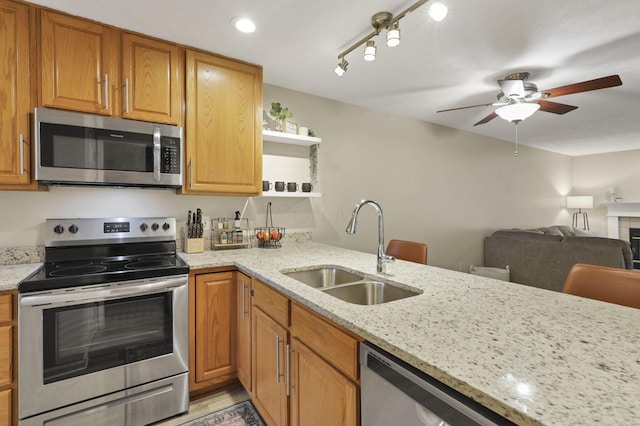4832 Bay Grove Ct, Groveport, OH 43125 - kitchen with stainless steel appliances, a sink, ceiling fan, open shelves, and light stone countertops