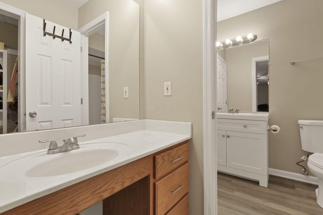 4832 Bay Grove Ct, Groveport, OH 43125 - full bath with toilet, vanity, wood finished floors, and baseboards