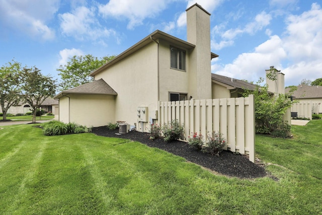 4832 Bay Grove Ct, Groveport, OH 43125 - view of side of property featuring a chimney, stucco siding, and central AC unit