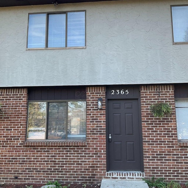 2363 Hampstead Dr Unit 2363-65-67, Columbus, OH 43229 - view of exterior entry featuring brick siding