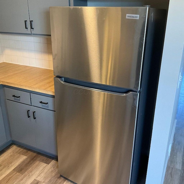 2363 Hampstead Dr Unit 2363-65-67, Columbus, OH 43229 - kitchen with freestanding refrigerator, gray cabinetry, light wood-style flooring, backsplash, and light countertops