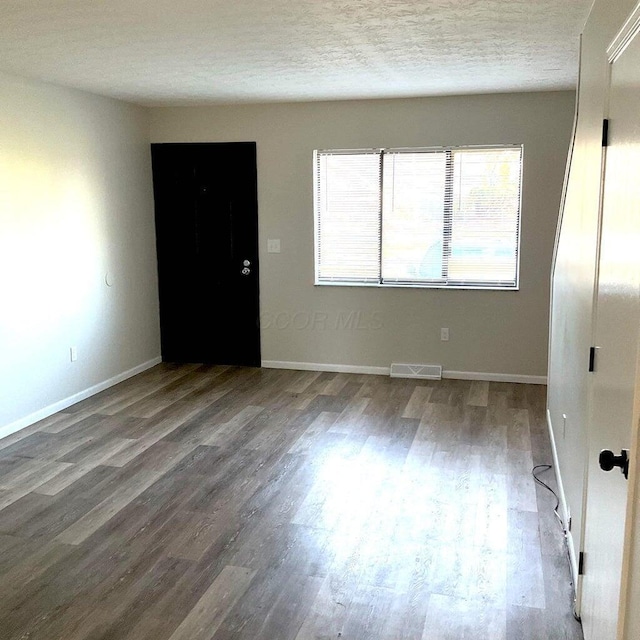 2363 Hampstead Dr Unit 2363-65-67, Columbus, OH 43229 - spare room featuring wood finished floors, a textured ceiling, and baseboards
