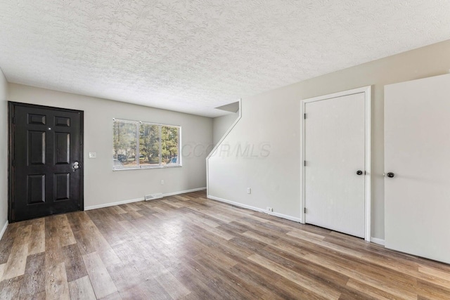 2363 Hampstead Dr Unit 2363-65-67, Columbus, OH 43229 - foyer with wood finished floors, a textured ceiling, and baseboards