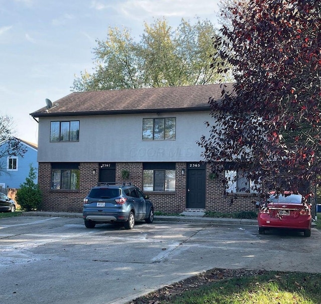 2363 Hampstead Dr Unit 2363-65-67, Columbus, OH 43229 - view of front of property featuring brick siding, stucco siding, and uncovered parking
