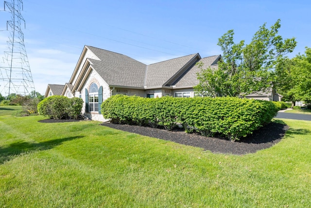 143 Falls Peak Ln, Delaware, OH 43015 - view of side of property featuring a lawn and roof with shingles