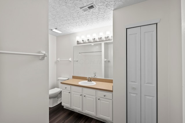 143 Falls Peak Ln, Delaware, OH 43015 - full bathroom with a closet, vanity, toilet, wood finished floors, and a textured ceiling