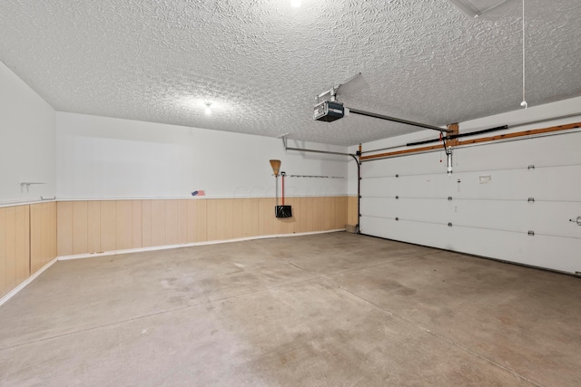 143 Falls Peak Ln, Delaware, OH 43015 - garage featuring a garage door opener and wainscoting