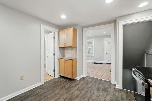 1146 Walters St, Columbus, OH 43201 - kitchen with light brown cabinetry, dark wood finished floors, recessed lighting, electric stove, and baseboards